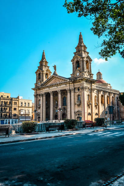 Street View Of St. Publius Parish Church In Floriana, Malta Street View Of St. Publius Parish Church In Floriana, Malta st julians bay stock pictures, royalty-free photos & images