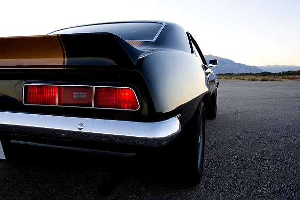 Close-up of the rear of a black and gold American muscle car stock photo