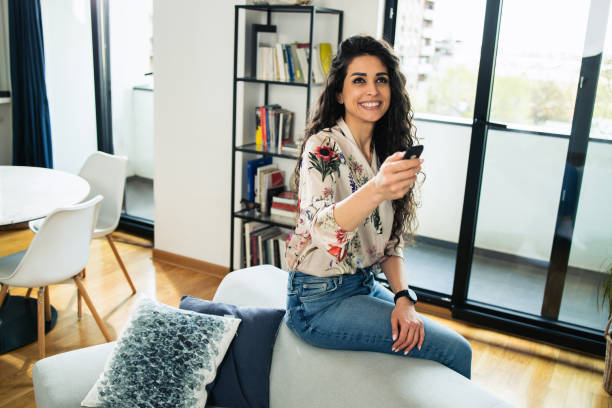 istock Happy woman using smart home technology at home 1746511403