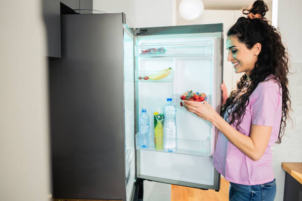 istock Woman looking at food in refrigerator 1746511453