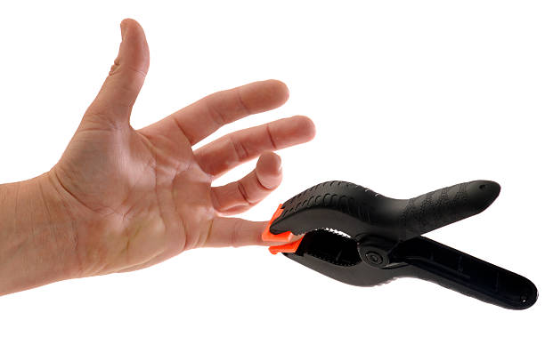 istock Painful Mistakes; Clamp Pinching Finger Tip 174651378