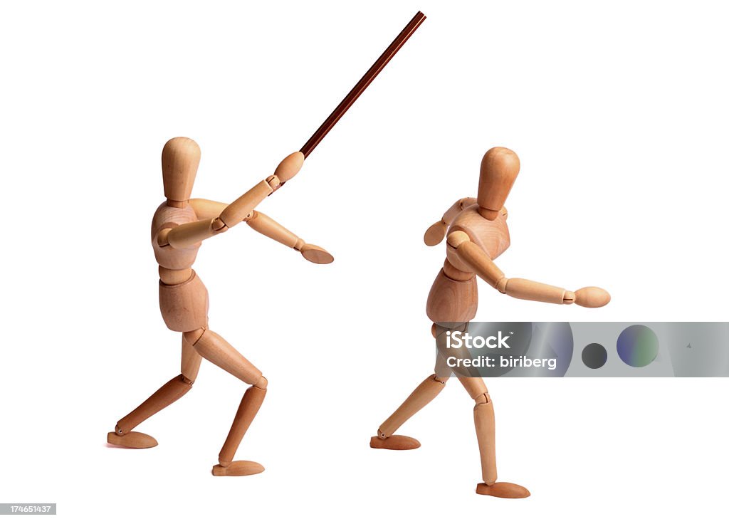Wooden mannequin beating an other one Wooden mannequin beating an other one with a pencil Arguing Stock Photo