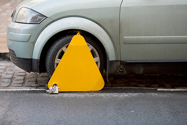 Clamped Car clamped in UK for road tax evasion car boot stock pictures, royalty-free photos & images