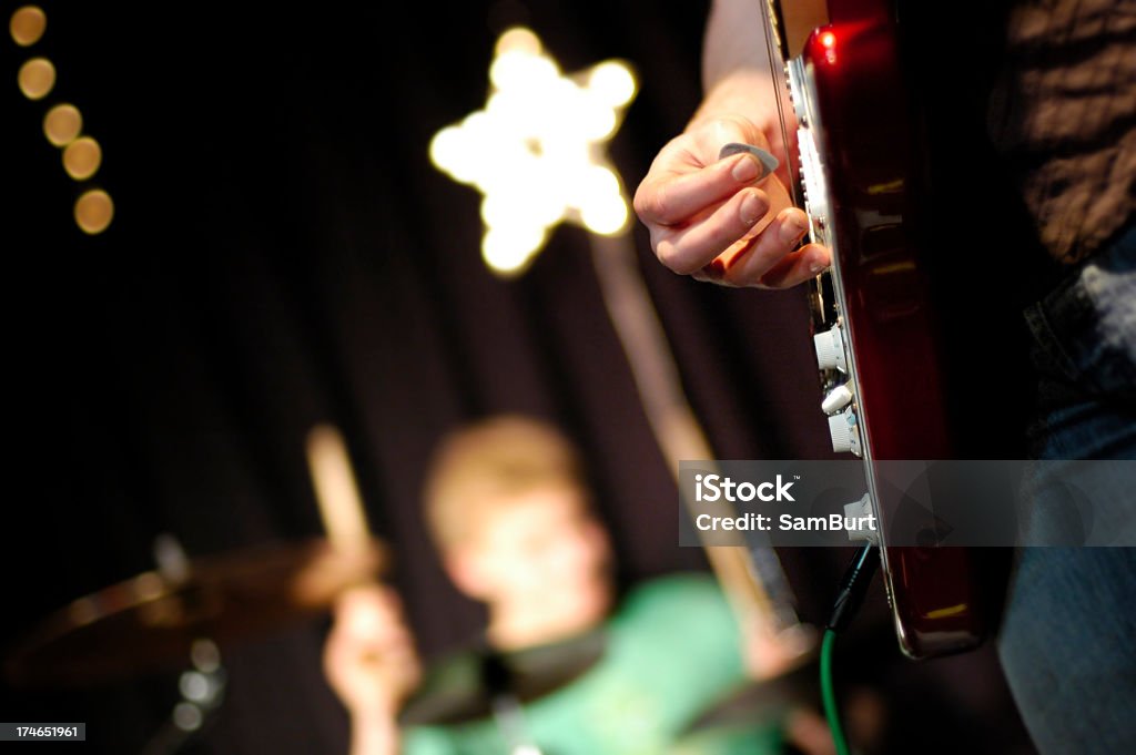 Rock Stars Royalty free stock photo of a guitarist and drummer on stage with star shaped light. Arts Culture and Entertainment Stock Photo