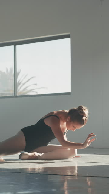 Creative dance, ballerina or woman on floor in gym, academy or class with flexible body, energy and talent. Ballet dancer training in studio for modern performance with music, freedom and movement.
