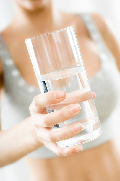 istock Woman's hand with glass of water 174652756
