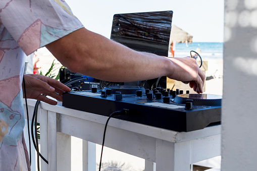 a deejay's console with a sea view background