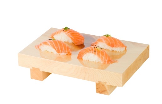 Salmon nigiri sushi on wooden tray. Isolated on pure white. Clipping path included.See also: