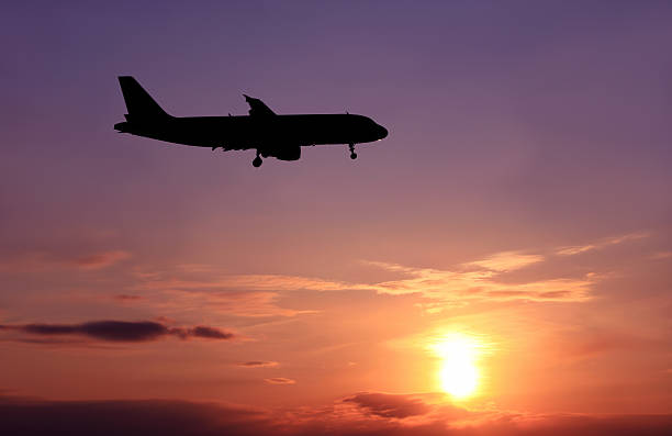 istock Silhouette of airplane flying at sunset. 174653895