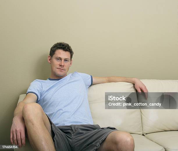 Man On Sofa Stock Photo - Download Image Now - Men, T-Shirt, Home Interior