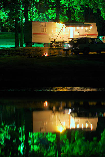 istock Night camping by lake in trailer 174654679