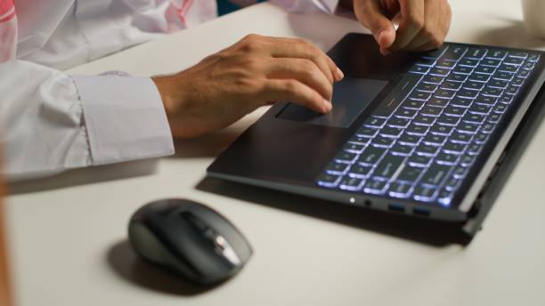 Businessman typing on laptop keyboard