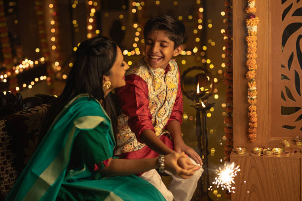 istock Mother with son playing with sparklers at home 1746548242