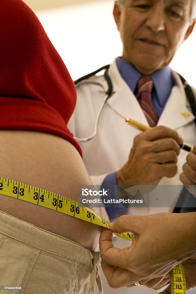 Primer plano de mujeres embarazadas de vientre medida médico en el fondo - Foto de stock de Adulto libre de derechos