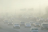 Cars at Rush Hour Driving Through Thick Smog