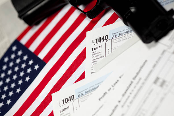 istock Taxes and a Gun 174655903
