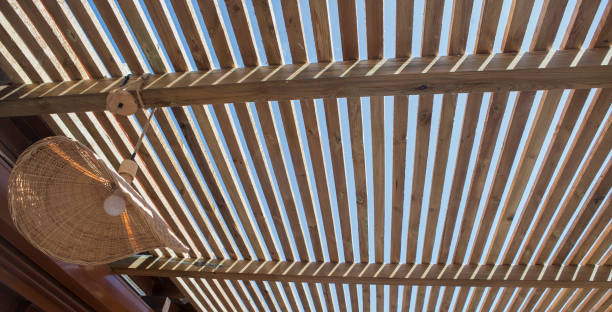 istock Rays of sunlight filtering through a wooden pergola 1746561598