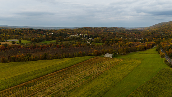 Farmland in Pennsylvania, Poconos Region in autumn in cloudy, murky afternoon. Overcasted dramatic sky.