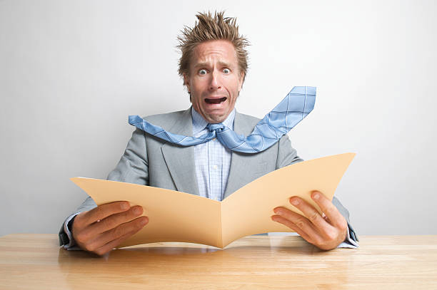 istock Stressed Businessman Office Worker Opening Folder at Desk 174656546