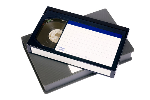 A Betacam format video cassette over it's case, isolated in white