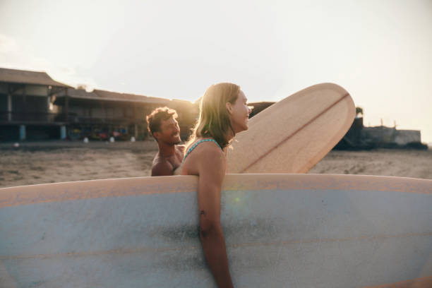 istock young couple going surfing at dawn 1746567593