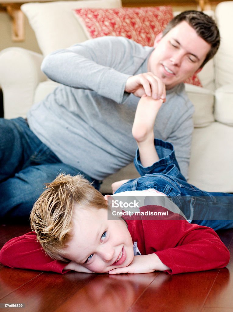 Happy Feet Parent tickling child's feet.  Focus on little boy. Bonding Stock Photo