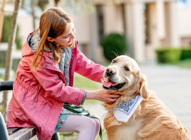 istock Girl with golden retriever dog 1746569652