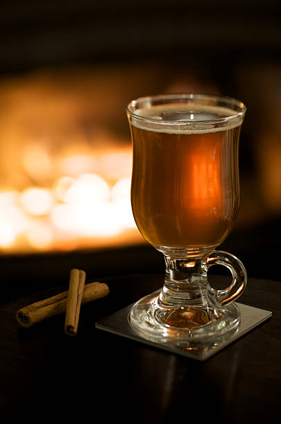 Hot Apple Cider by a Fireplace stock photo