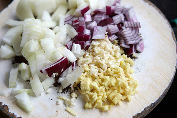 Finely chopped onion "Finely chopped red and white onion, with garlic and ginger  on board" finely stock pictures, royalty-free photos & images