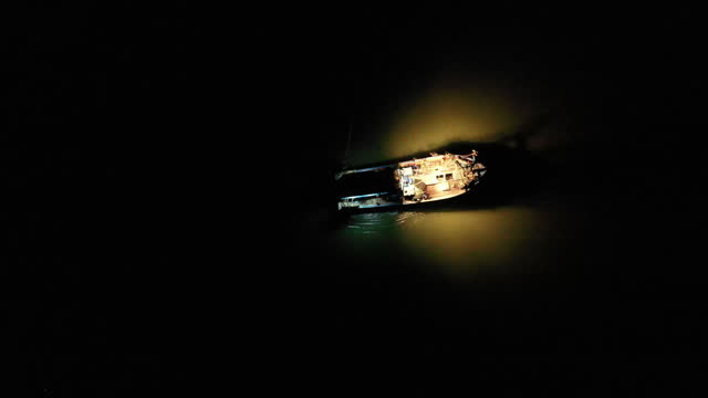 Aerial top view of the trawler fishing at night