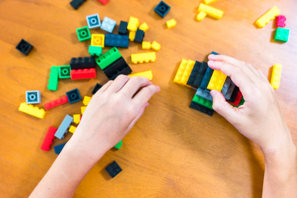 istock children's toy constructor Focus on a specific point
Closeup of children's hands playing with many colorful plastic blocks. Children have fun building robots. Relaxation created with modern techniques and robots. Meditation practice. 1746576757