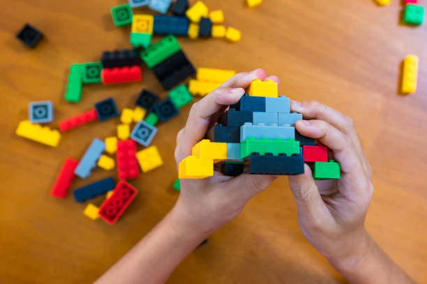 istock children's toy constructor Focus on a specific point
Closeup of children's hands playing with many colorful plastic blocks. Children have fun building robots. Relaxation created with modern techniques and robots. Meditation practice. 1746576760