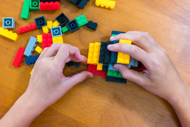istock children's toy constructor Focus on a specific point
Closeup of children's hands playing with many colorful plastic blocks. Children have fun building robots. Relaxation created with modern techniques and robots. Meditation practice. 1746577285