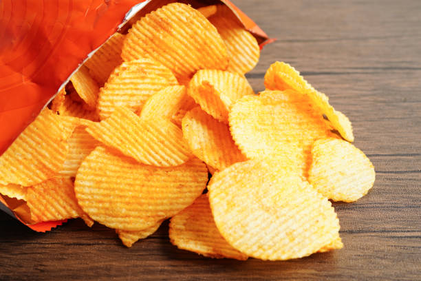 istock Potato chips in open bag, delicious BBQ seasoning spicy for crips, thin slice deep fried snack fast food. 1746577348