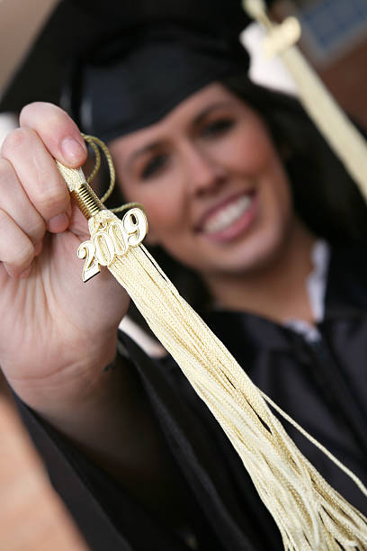 istock Young Woman Holding Up Her 2009 Tassel 174657900
