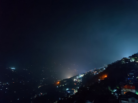 Night panoramic landscape view of lit scenic Gangtok located in the eastern Himalayan range at an elevation of 1,650m. Famous for tourism; it is state capital and the largest city of Sikkim, India.
