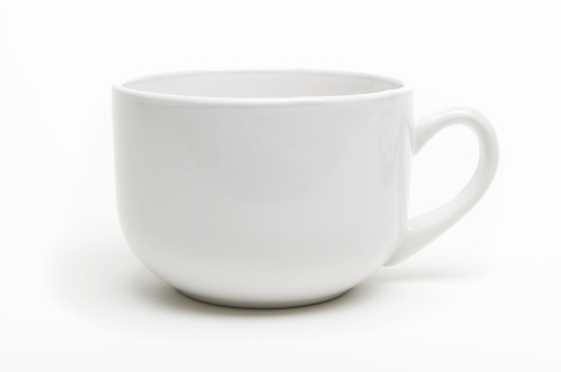 Simple generic white coffee mug with a bit of shadow on white background