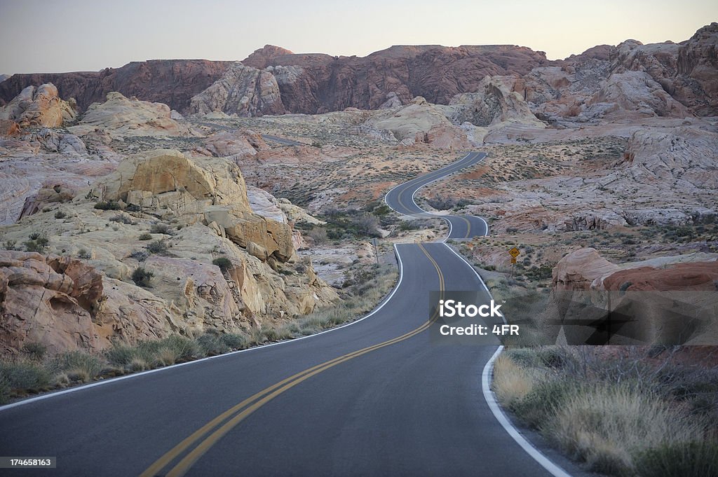 Valley of Fire, Nevada, USA Road leading through Valley of Fire right after sunset. Nikon D3. Backgrounds Stock Photo