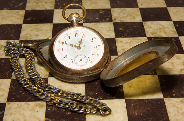 istock antique pocket watch on chess board 174658578