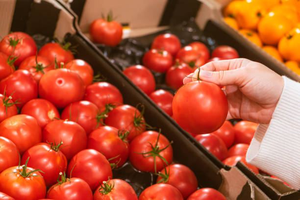 istock hand taking tomatoes from grocery store shelf 1746585799