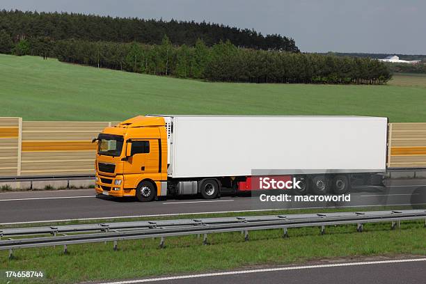 A Large Yellow Truck On The Highway Stock Photo - Download Image Now - Advertisement, Agricultural Activity, Commercial Land Vehicle