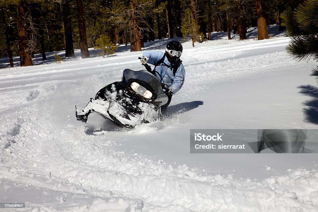 Snowmobiling Lone rider on a snowmobile near California's Mammoth Mountain. Snowmobile Stock Photo