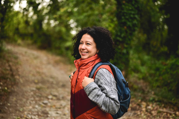 istock woman hiking through a forest. 1746589694