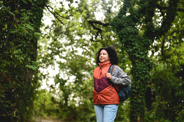 istock Multiracial female hiker with backpack walk through the forest. 1746589700