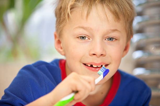 istock healthy boy cleaning his teeth 174659218