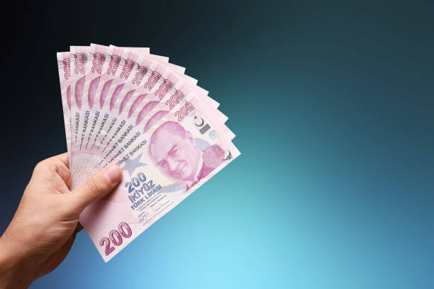 istock Hand holding Turkish lira banknotes 1746593269