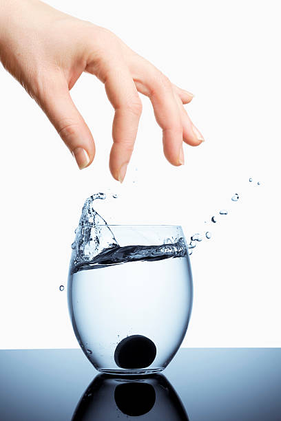 tea glass of water standing on table with blue and white cloth