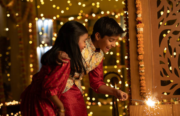 istock Happy siblings playing with sparklers at home during Diwali 1746599362