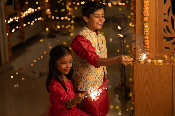 istock Happy siblings playing with sparklers at home during Diwali 1746600210