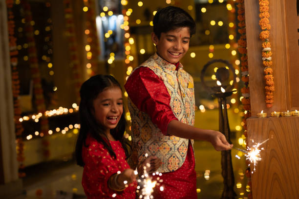 istock Happy siblings playing with sparklers at home during Diwali 1746600744